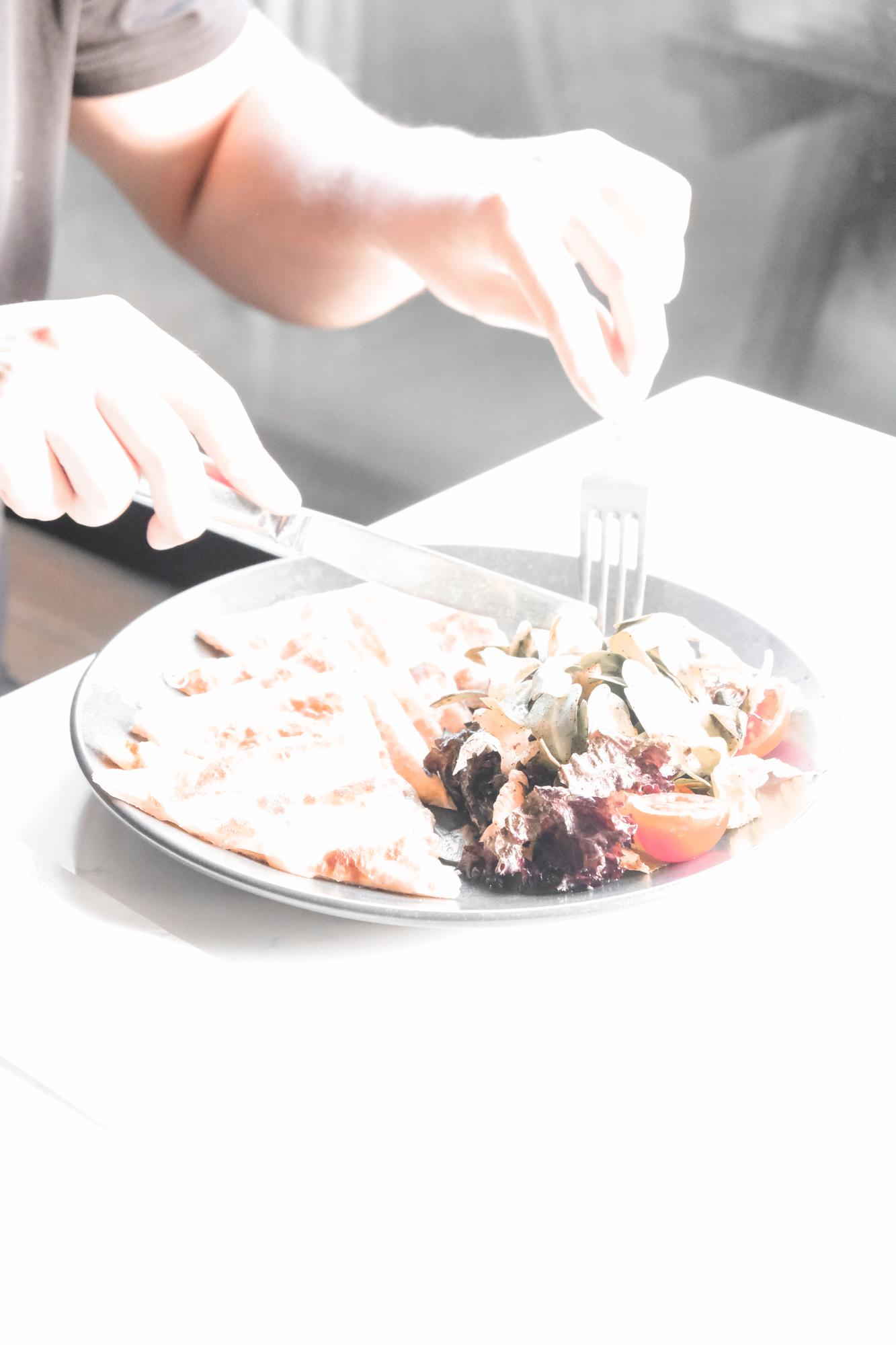 Chef handing plated dish to guest at private table